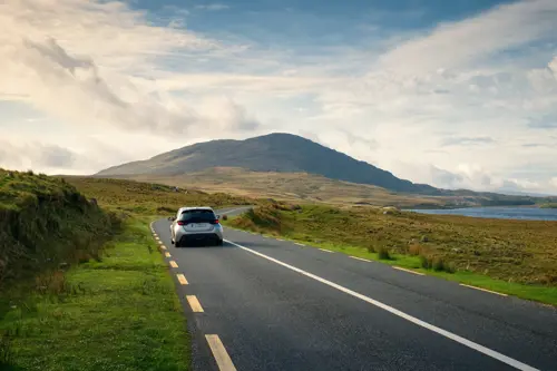 Car driving on scenic road in Connemara National park in county Galway, Ireland