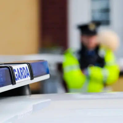 Garda Siochana Irish Police Officer Behind A Police Car
